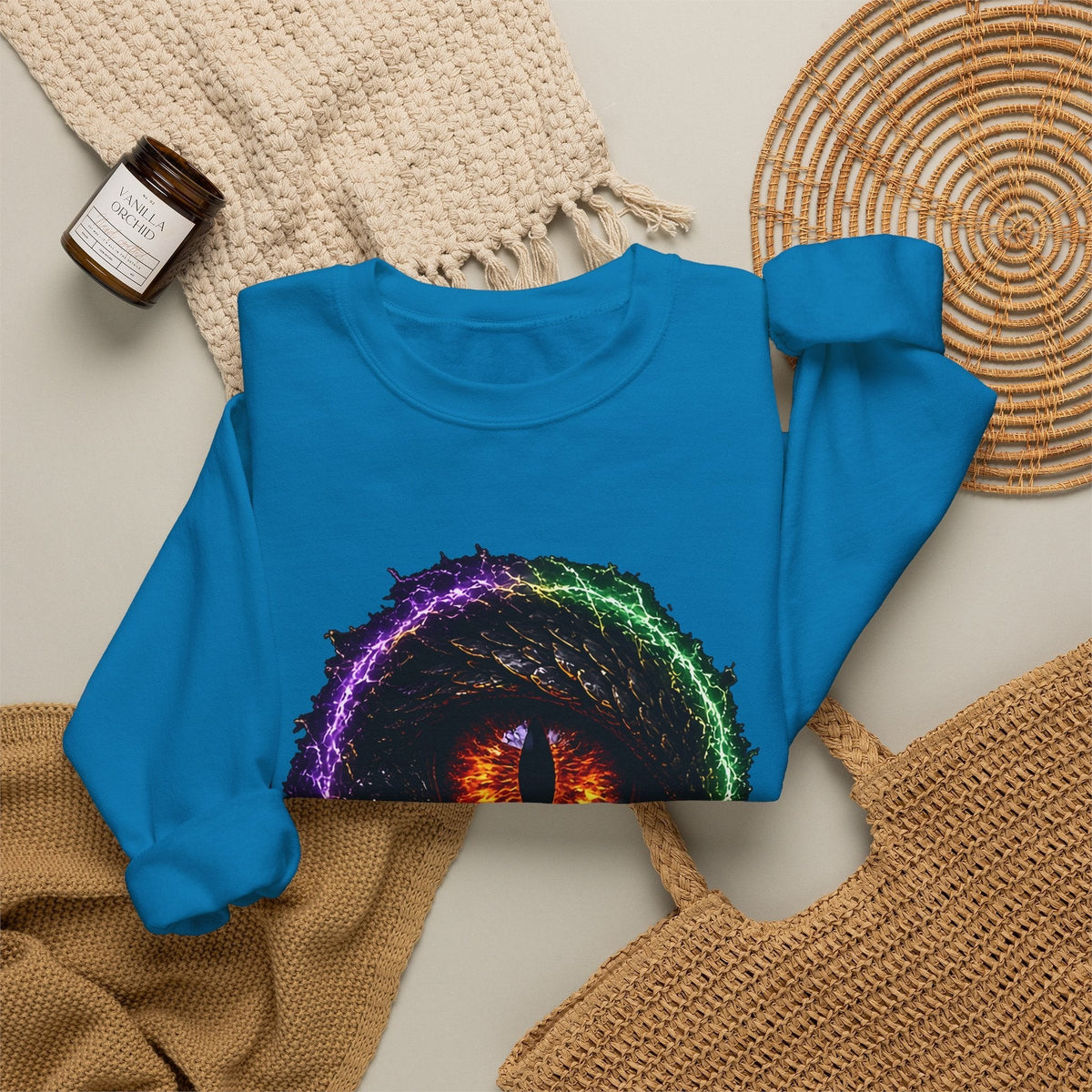 Dragon Eye crewneck sweatshirt in sapphire, flat lay: fire-lit dragon eye front