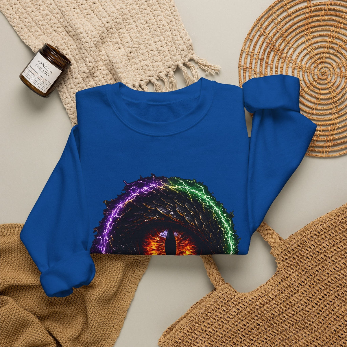 Dragon Eye crewneck sweatshirt in royal, flat lay: fire-lit dragon eye front