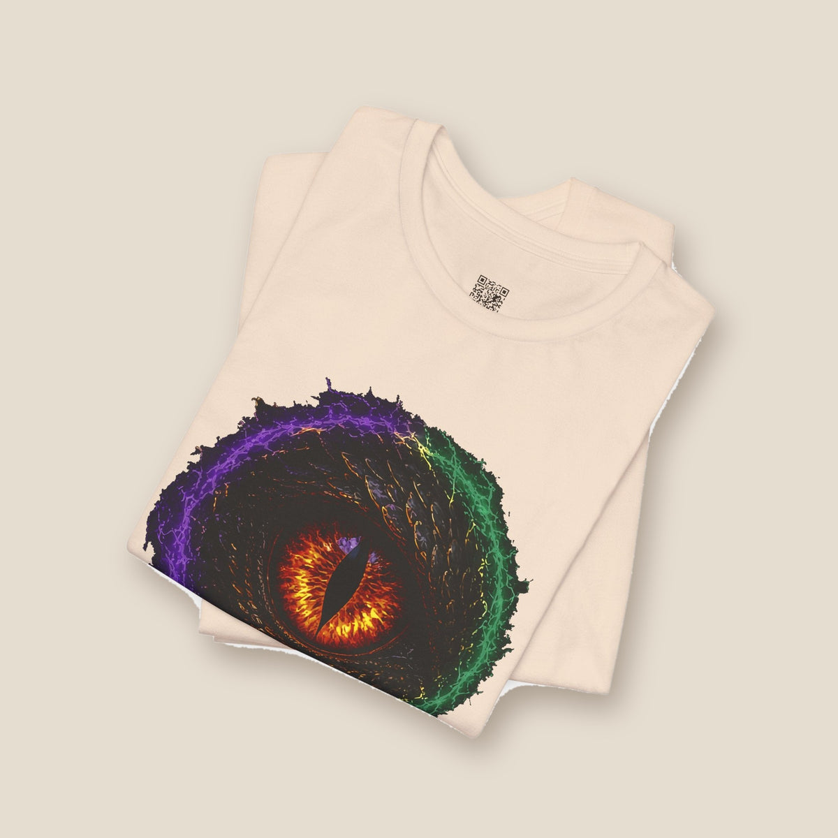 Dragon Eye graphic tee in soft cream, folded: fire-lit dragon eye front
